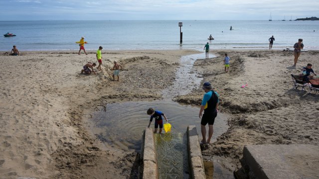 Article thumbnail: SWANAGE, ENGLAND - AUGUST 19: Beach goers are seen enjoying the weather at the beach, on August 19, 2022 in Swanage, United Kingdom. Swanage was named, on Wessex Water's website, as one of the beaches where sewage was discharged on Wednesday??August 17th. (Photo by Finnbarr Webster/Getty Images)