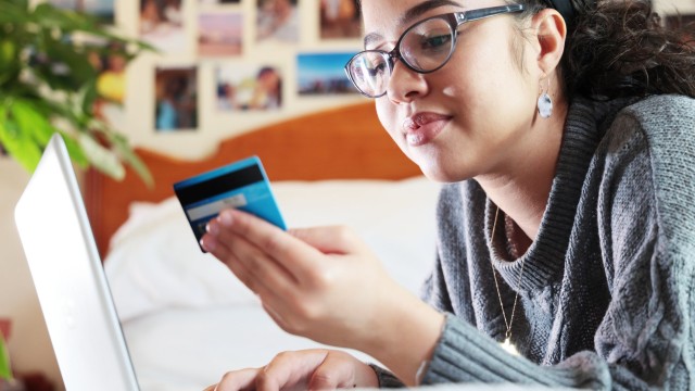 Article thumbnail: mixed race woman using laptop and credit card to pay for services or goods
