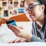 Article thumbnail: mixed race woman using laptop and credit card to pay for services or goods
