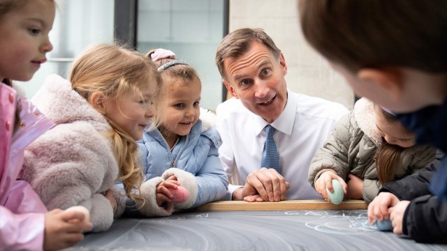 Article thumbnail: Britain's Chancellor of the Exchequer Jeremy Hunt meets children during a visit to Busy Bees Battersea Nursery in south London, on March 15, 2023, after delivering his Budget earlier in the day. (Photo by Stefan Rousseau / POOL / AFP) (Photo by STEFAN ROUSSEAU/POOL/AFP via Getty Images)