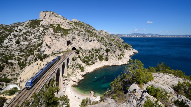 Article thumbnail: Train Crossing the La Vesse Viaduct at Niolon, on the C??te Bleue or Blue Coast Railway, a Coastal Railway along the Mediterranean Coast between Marseille & Martigues. The view shows the Vesse calanque or cove with the Bay of Marseille and Marseille in the distance.