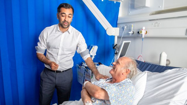 Article thumbnail: Humza Yousaf meets patient Paul MacIntosh during a visit to NHS Forth Valley Royal Hospital in Larbert, to mark the 75th anniversary of the NHS, on Monday (Photo: PA)