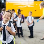 Article thumbnail: Portrait of a schoolboy in front of school bus