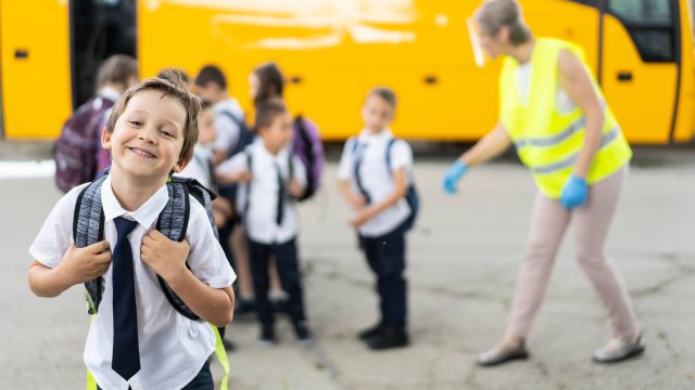 Article thumbnail: Portrait of a schoolboy in front of school bus
